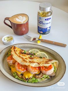 a plate with a sandwich on it next to a cup of cappuccino