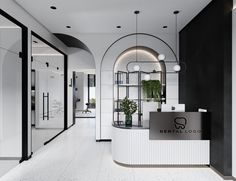 the front desk of a dental office with black and white walls, arched doorways, and plants in pots