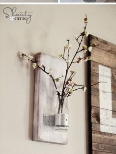 a vase filled with flowers sitting on top of a wooden shelf next to a painting