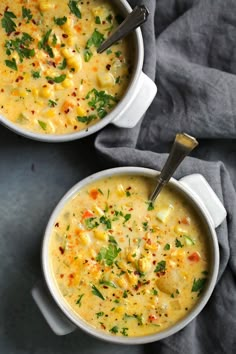 two white bowls filled with soup on top of a table