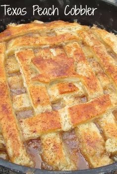 a close up of a pie in a pan on a stove with the words texas peach cobbler written above it