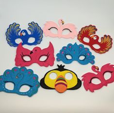 a group of masks with different designs and colors are shown in front of a white background