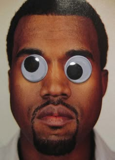 a close up of a man with two eyes on his face and an eyeball in front of him