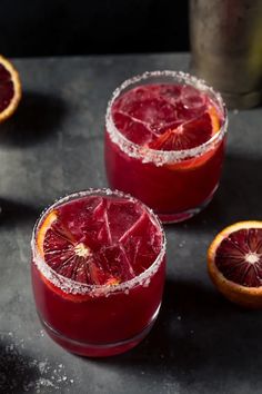 two glasses filled with blood orange margaritas