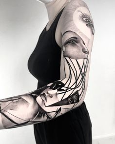 a woman's arm with an abstract tattoo design on her left arm and shoulder