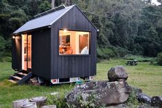 a tiny cabin is built into the side of a hill