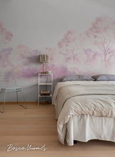 a bedroom with pink trees painted on the wall and white bed in front of it