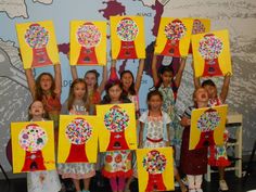 a group of children holding up paintings in front of a wall