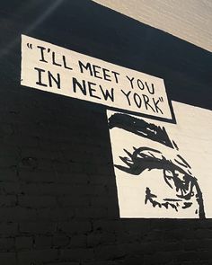 a black and white mural on the side of a building that says i'll'll meet you in new york