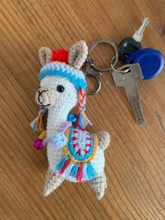 a crocheted llama keychain sitting on top of a wooden table