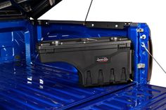 the back end of a blue truck with an open trunk and tool box on it