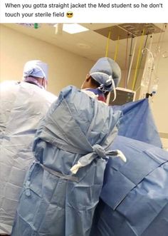 two doctors in scrubs standing next to each other with medical equipment wrapped around them