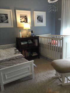 a baby's room with blue walls and white furniture