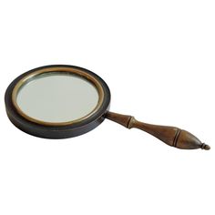 a magnifying glass sitting on top of a wooden handle