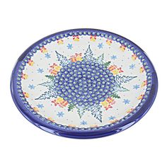 a blue and white plate with an intricate design on the rim, in front of a white background