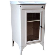 a white cabinet with an open door on the front and bottom shelf is shown against a white background