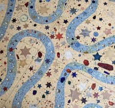 the floor is decorated with many different colored stars and shapes, including blue swirls