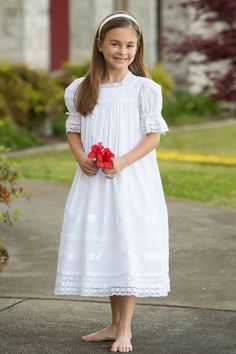 Capturing the charm of the south, the Virginia Lace Girls Dress is the perfect heirloom piece for a special occasion. This radiant dress is made with the finest lace and satin ribbon in a choice of white or ivory for an exquisite look. The mid-calf length and classic French seams define it as an exquisitely timeless piece to be cherished for years to come. Heirloom First Communion Dress, Vintage Flower Girls, Vintage Dress Design, Girls Cotton Dresses, Heirloom Dresses, Vintage Girls Dresses, Girls White Dress, First Communion Dress, First Communion Dresses