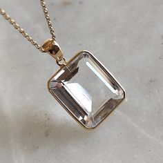 This stunning Pendant is set in 14k Solid Yellow Gold with clear quartz with utmost precision. It is a unique gemstone Pendant for nearly every occasion and is completely hassle-free jewelry. ITEM DETAILS: * GEM: Clear Quartz * GEM SIZE: 13X15mm * GEM SHAPE: Octagon * Gem weight: 9.60 carats * Gold Purity: 14KT  * Gold Weight: 0.64 gram * Total Weight of the Pendant: 2.56 gram The Gold purity is guaranteed and it comes with authentic 14KT gold hallmark. Since my items are handmade, they are abso Timeless Crystal Jewelry As A Gift, Timeless Crystal Jewelry For Gifts, Timeless Faceted Jewelry For Gift, Crystal Jewelry With Rectangular Stone For Gift, Timeless Rectangular Stone Jewelry For Gift, Timeless Rectangular Stone Jewelry Gift, Emerald Cut Jewelry With Si Clarity As Gift, Elegant Clear Jewelry For Gifts, Classic Clear Gemstone Jewelry