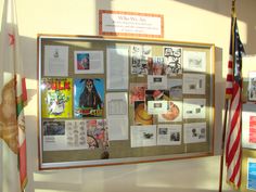 a bulletin board with pictures and flags on it