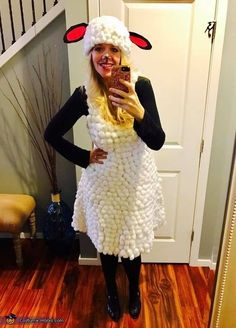 a woman dressed as a sheep taking a selfie