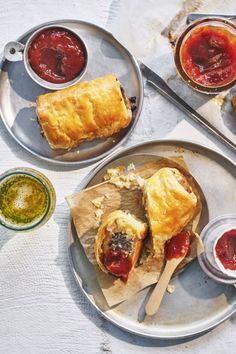 two plates with pastries and sauces on them