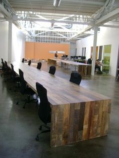 an empty conference room with wooden tables and chairs