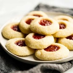 a white plate topped with cookies covered in jelly