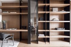 an office with wooden shelves and black chairs