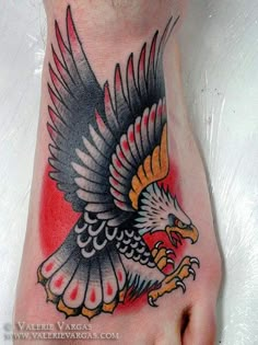 a foot with an eagle tattoo on it