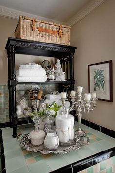 a dining room table with candles and dishes on it