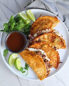 a white plate topped with tacos and sauce