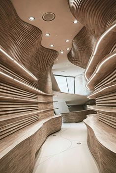 the interior of a modern building with wooden slats on the walls and flooring