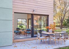 an outdoor dining area with sliding glass doors leading to the back deck and patio outside