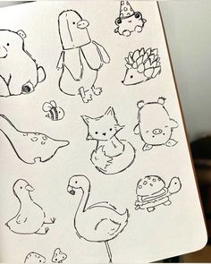 an open notebook with drawings of animals on it