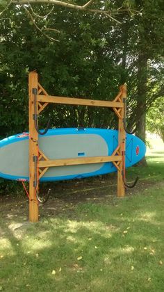 a blue surfboard sitting on top of a wooden rack