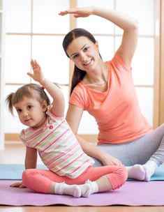 a woman and her daughter doing yoga together