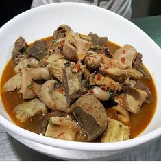 a white bowl filled with food on top of a table