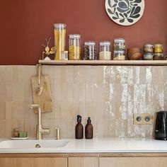 the kitchen counter is covered with jars and spices