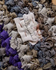 a close up of a piece of cloth with words on it and some thread in the middle