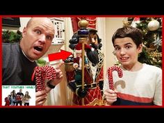 a man and boy holding candy canes in front of a christmas tree with an ornament