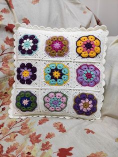 a crocheted pillow with flowers on it