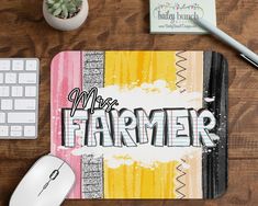 a mouse pad with the words more farmer on it next to a keyboard and computer