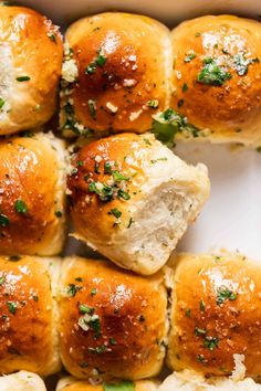 several rolls with cheese and herbs on them