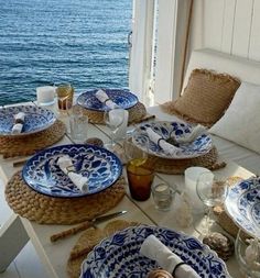 the table is set with blue and white plates