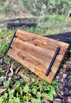 a wooden notebook sitting on the ground next to a tree