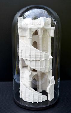 a model of a castle under a glass dome on a black tableclothed surface