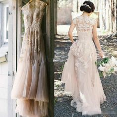 two dresses are shown on display in front of a window, and one is wearing a gown