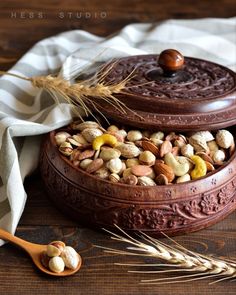 a wooden bowl filled with nuts and cereal