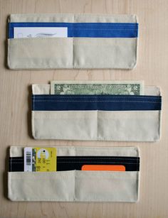 three wallets with money sticking out of them sitting on a table next to each other